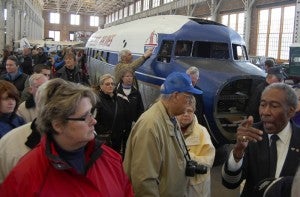 Retired pilot Bill Wilkerson, right, who flew for Piedmont Airlines, leads a tour of the restoration of a DC-3 airplane used by Piedmont Airlines at the N.C. Transportation Museum Saturday. Wilkerson is part of a group of volunteers working to restore the plane.