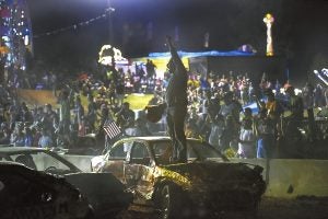 A drive who was knocked out of the race early celebrated for the winning driver in the compact car category in the Demolition Derby.photo by Wayne Hinshaw, for the Salisbury POST