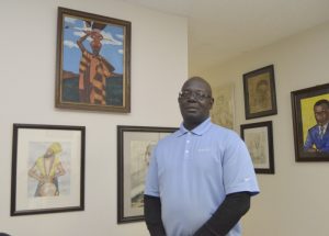 E & M Gallery co-owner Elijah Belton stands before some of his artwork that includes promient figures in black history and locally known African Americans. His work along with business partner Mickey Chambers have their work on display with featured artist Delores Medlin. The gallery is located on South Main Street in a shared space with Two Dots & a Mae Resale Store. Shavonne Walker/Salisbury Post