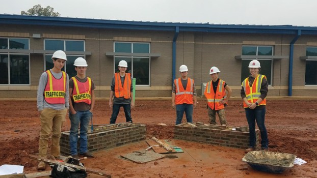 Masonry students from West Rowan High build symbolic benches for new